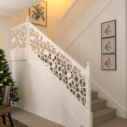 Staircase with honeycomb pattern railing and a decorated Christmas tree.
