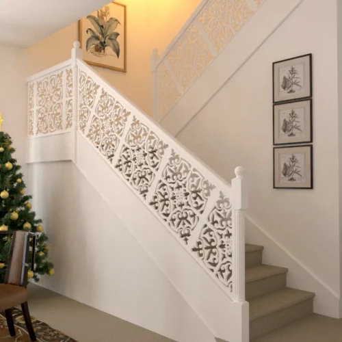 Modern staircase with floral pattern railing and framed pictures on the wall.